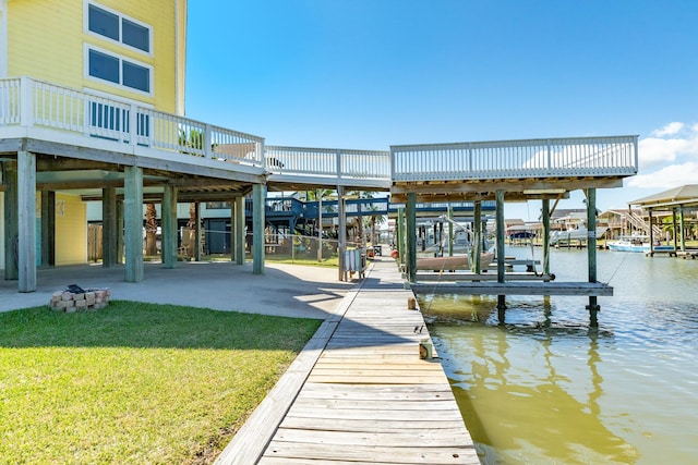 dock area featuring a lawn and a water view