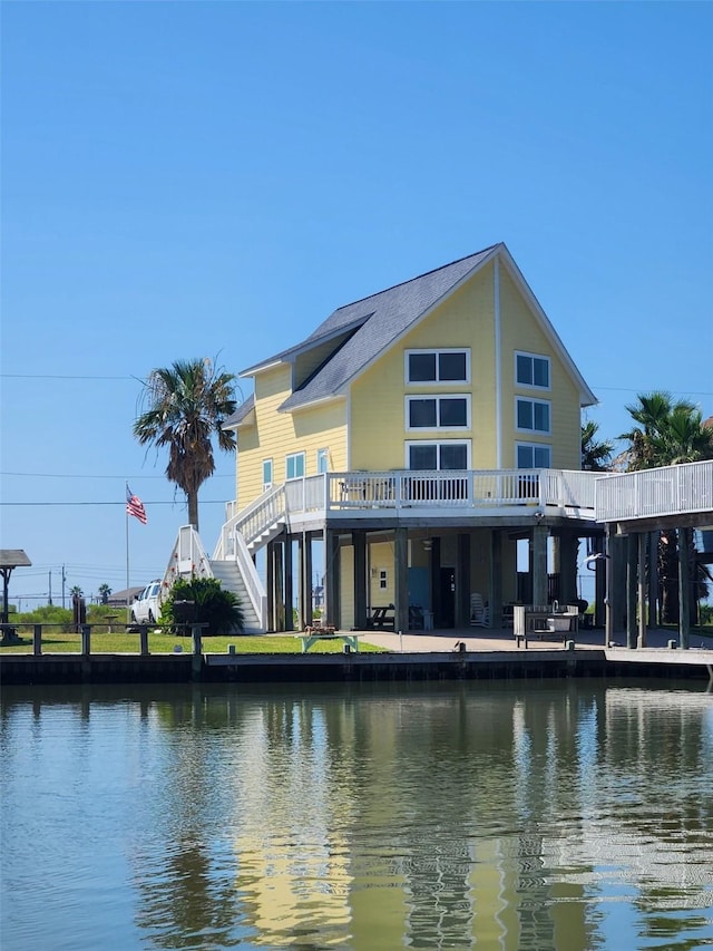 rear view of property with a water view