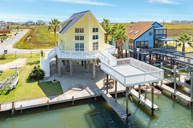 back of property with a deck with water view