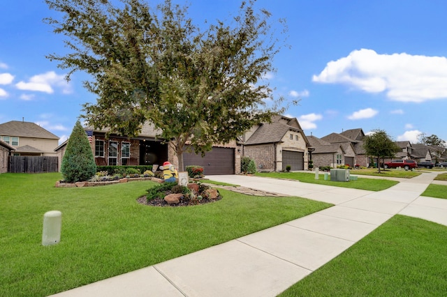 view of front facade featuring a front yard, a garage, and central air condition unit