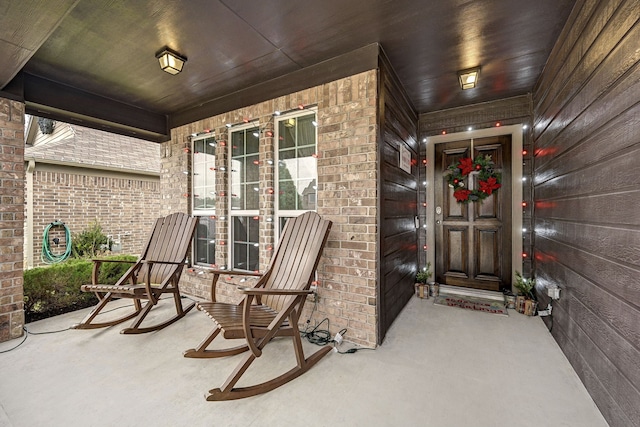 view of exterior entry featuring a porch