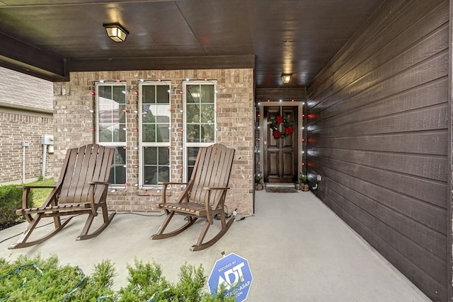 view of exterior entry with covered porch