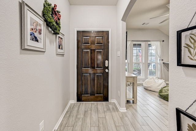 entrance foyer featuring lofted ceiling and ceiling fan