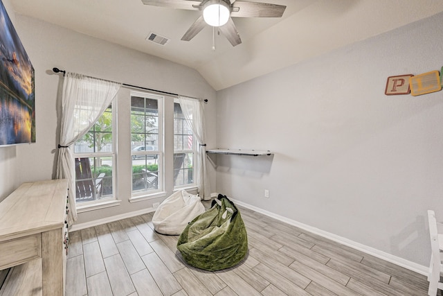 sitting room featuring light wood-type flooring, ceiling fan, lofted ceiling, and plenty of natural light