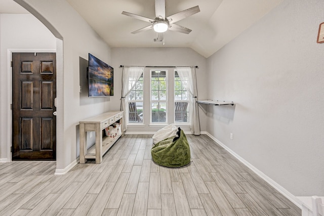 interior space featuring ceiling fan, lofted ceiling, and light wood-type flooring