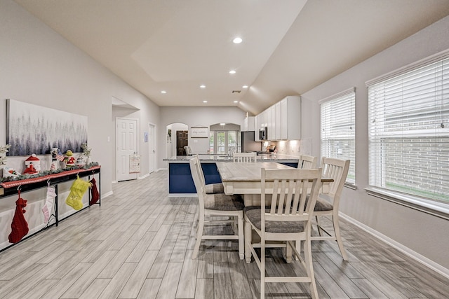 dining space featuring lofted ceiling