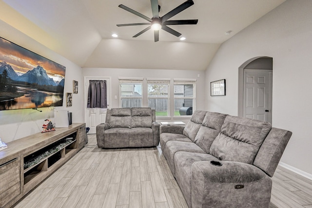 living room featuring ceiling fan and lofted ceiling