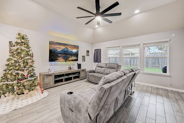 living room with ceiling fan and lofted ceiling