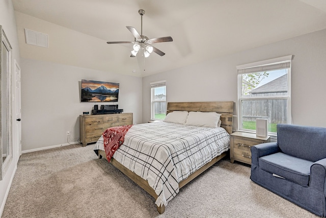 carpeted bedroom featuring ceiling fan and multiple windows