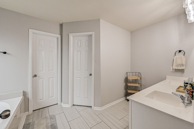 bathroom with vanity and a tub