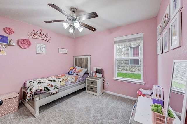 carpeted bedroom featuring ceiling fan and multiple windows