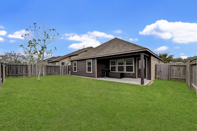 rear view of property with a patio area and a lawn