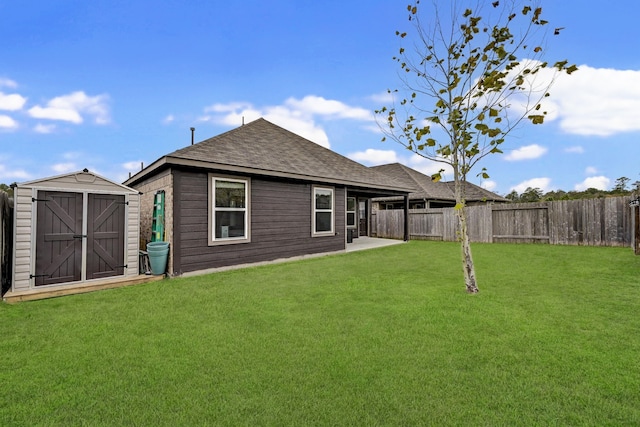 back of house with a storage shed, a patio, and a yard