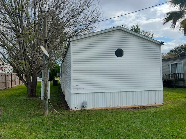 view of side of property with a lawn