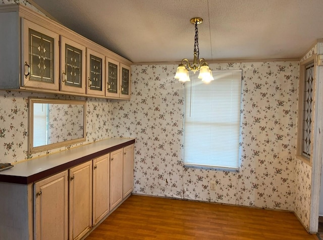 interior space with ornamental molding, hardwood / wood-style flooring, hanging light fixtures, and a notable chandelier