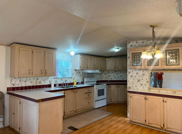 kitchen featuring lofted ceiling, white range with electric cooktop, sink, light hardwood / wood-style flooring, and decorative light fixtures