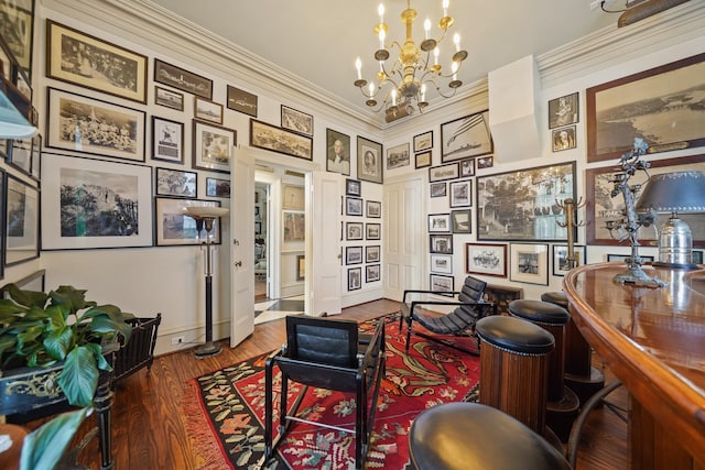 office space with hardwood / wood-style floors, ornamental molding, and a notable chandelier