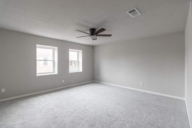 spare room featuring carpet and ceiling fan