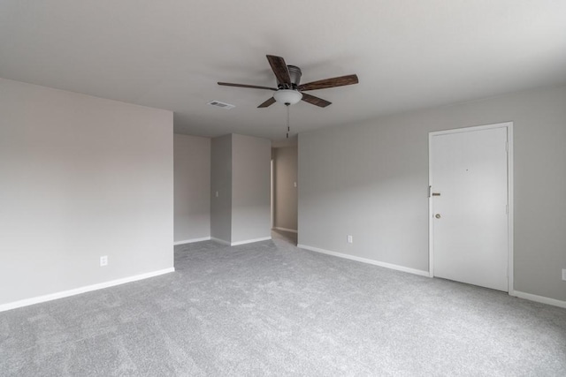 unfurnished room with ceiling fan and carpet