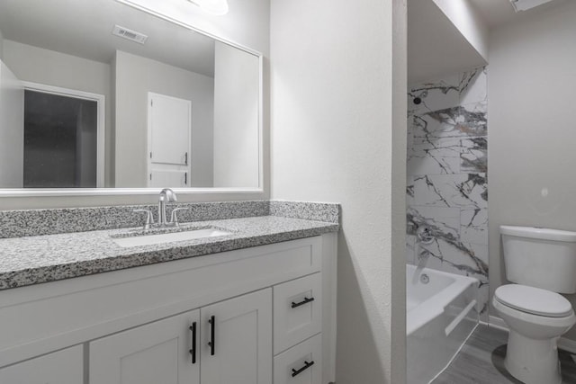 full bathroom featuring hardwood / wood-style floors, vanity, toilet, and tiled shower / bath