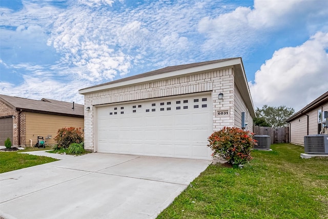 garage featuring central air condition unit and a lawn