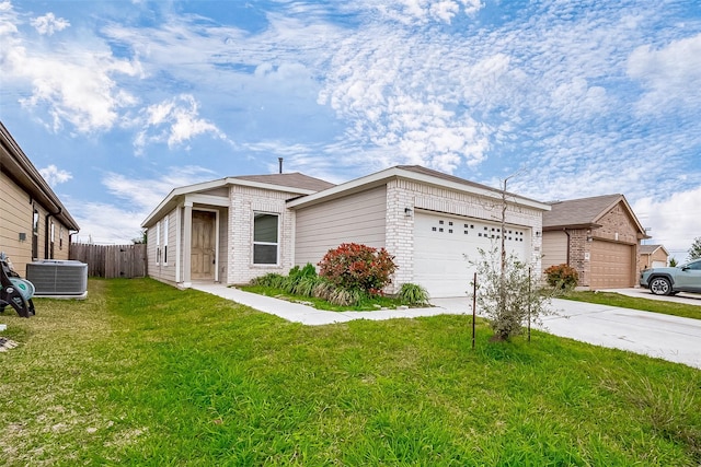 ranch-style house featuring a front yard, a garage, and central air condition unit