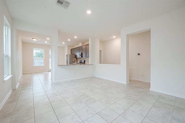 unfurnished living room with light tile patterned flooring