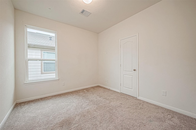 empty room featuring light colored carpet