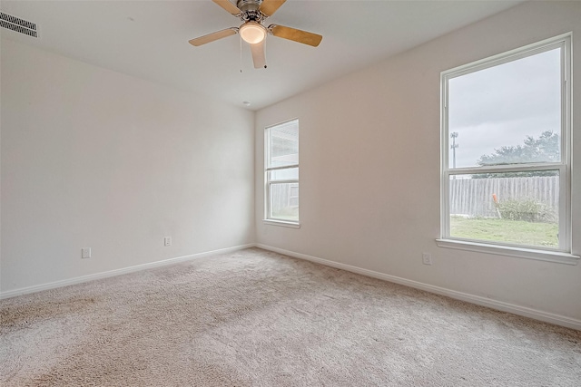 carpeted spare room with ceiling fan