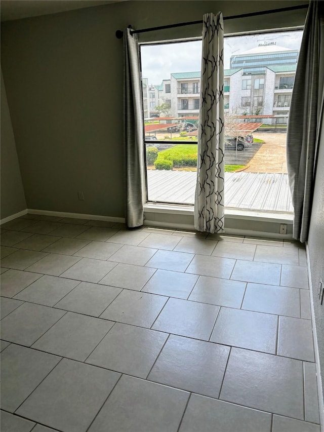 doorway with light tile patterned floors and plenty of natural light