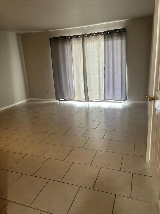 spare room with light tile patterned floors