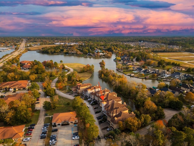 aerial view at dusk with a water view