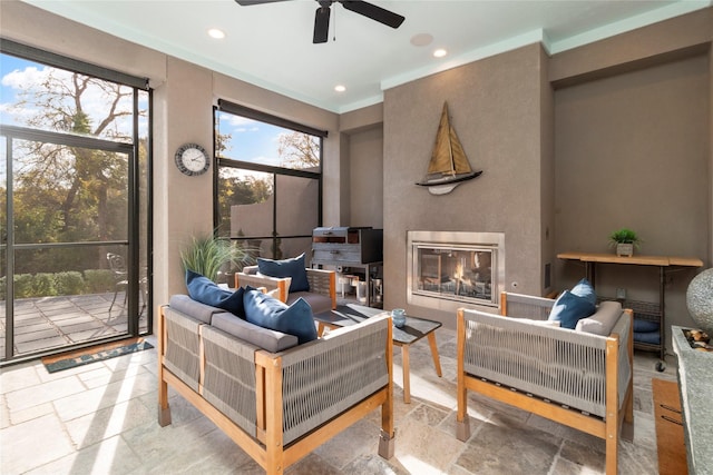 sunroom featuring ceiling fan