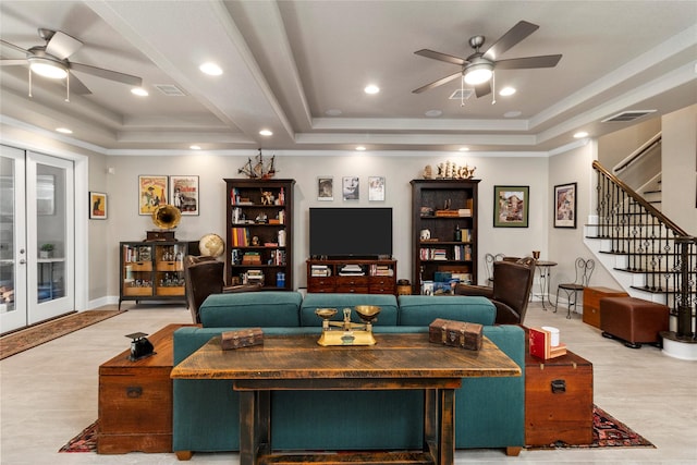 living room with ceiling fan, french doors, and a tray ceiling