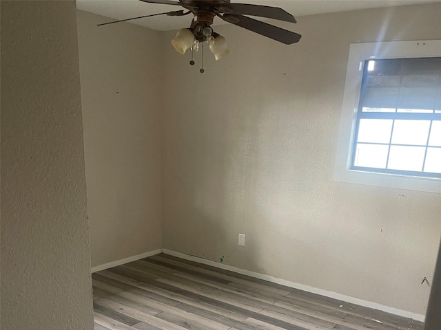 unfurnished room with wood-type flooring and ceiling fan