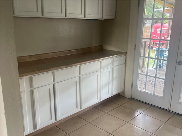 kitchen featuring white cabinets and light tile patterned floors