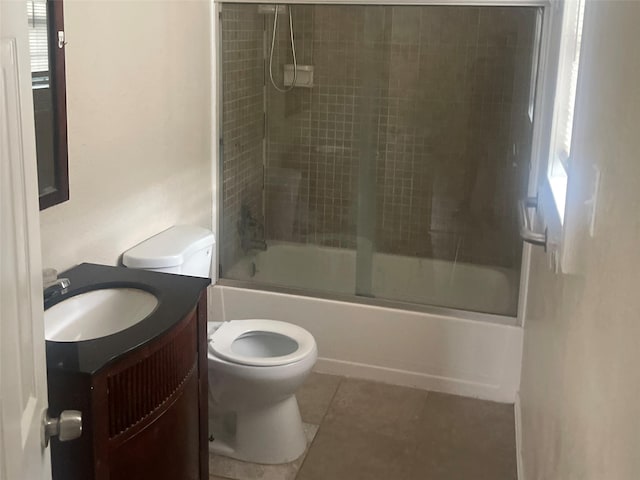 full bathroom featuring tile patterned flooring, vanity, toilet, and enclosed tub / shower combo