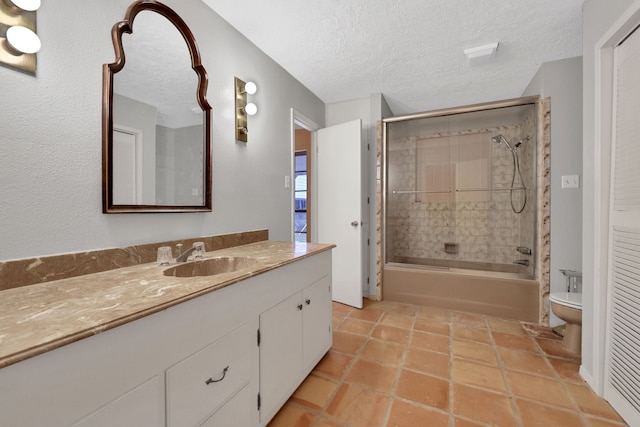 full bathroom featuring tiled shower / bath, vanity, a textured ceiling, and toilet