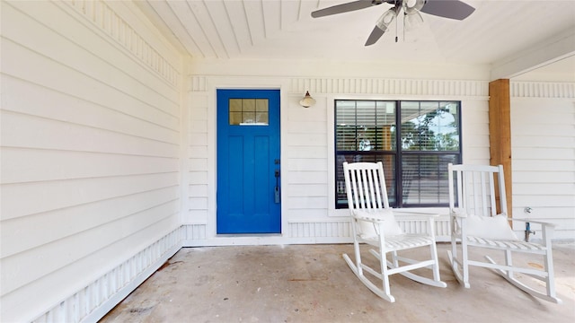 view of exterior entry with covered porch and ceiling fan