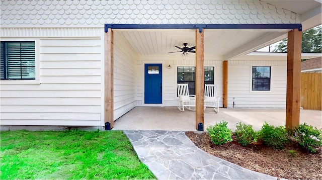 entrance to property with ceiling fan and a porch