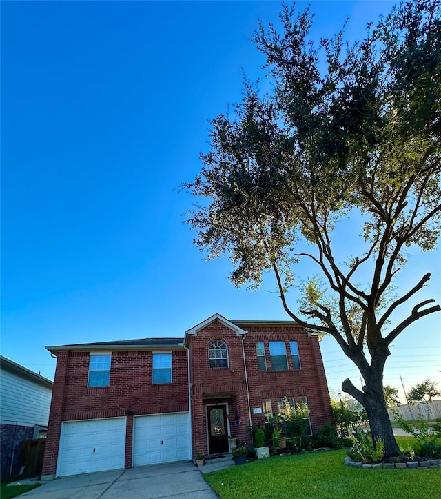 view of front of home featuring a front yard and a garage