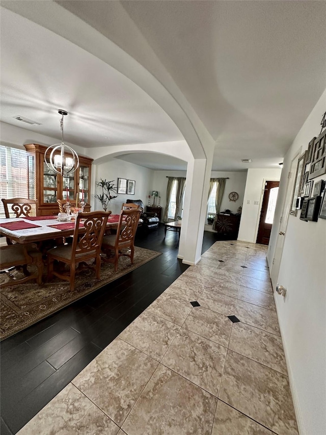 dining room featuring a chandelier and dark hardwood / wood-style floors