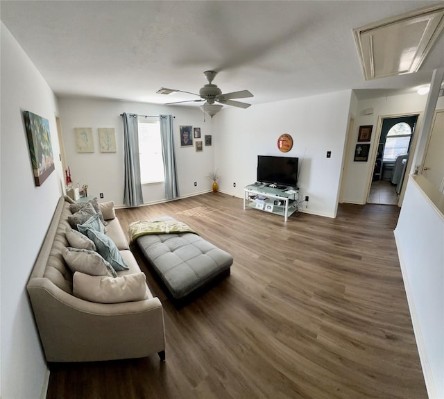 living room with a wealth of natural light, hardwood / wood-style floors, and ceiling fan