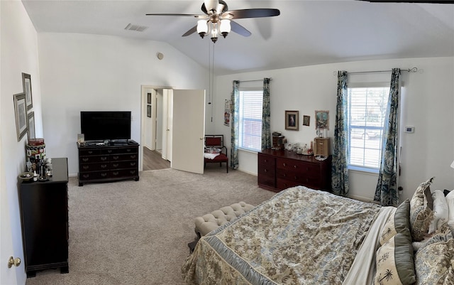 carpeted bedroom with multiple windows, ceiling fan, and lofted ceiling