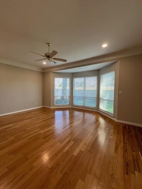 unfurnished room with hardwood / wood-style floors, ceiling fan, and ornamental molding