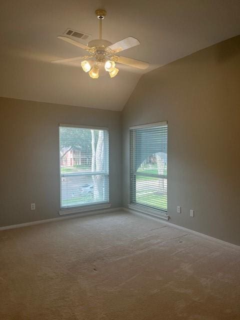 spare room with ceiling fan, carpet, and vaulted ceiling