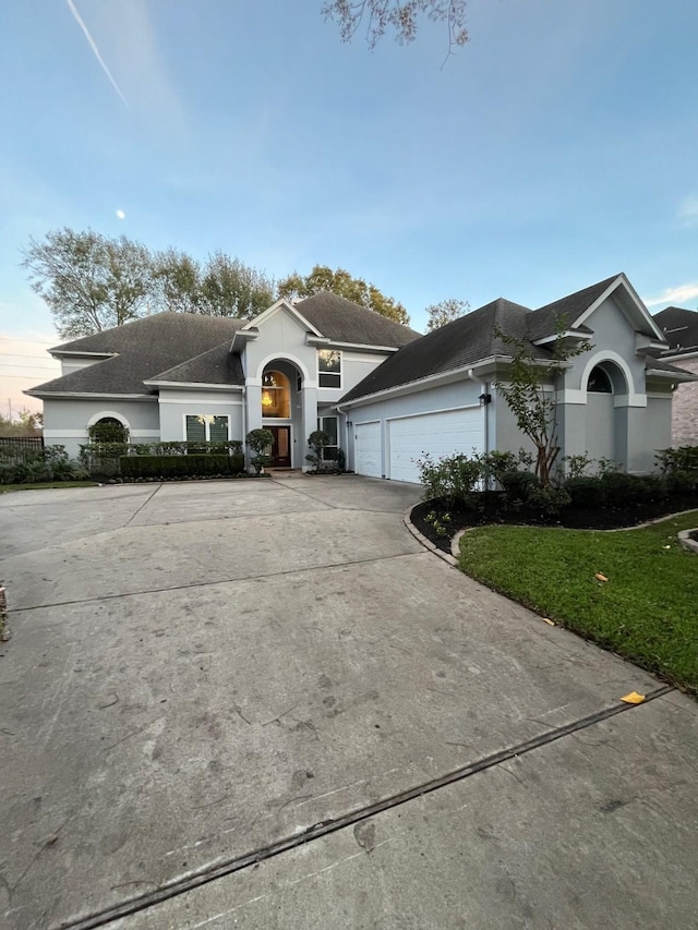 view of front of home with a yard and a garage