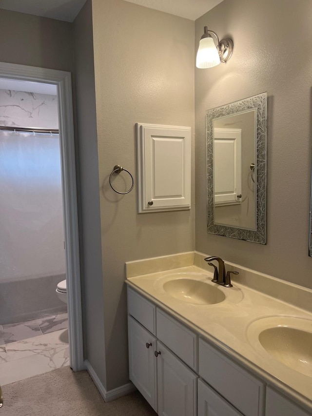 bathroom featuring vanity and toilet