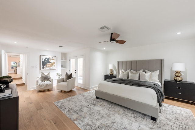 bedroom with ceiling fan, french doors, and light wood-type flooring