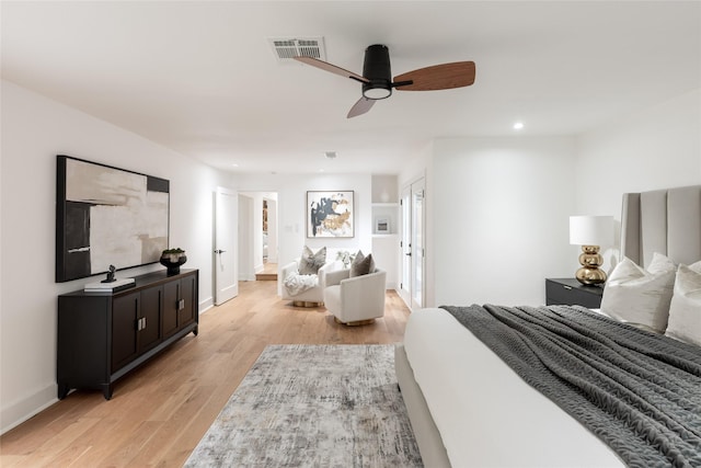 bedroom with light hardwood / wood-style floors and ceiling fan